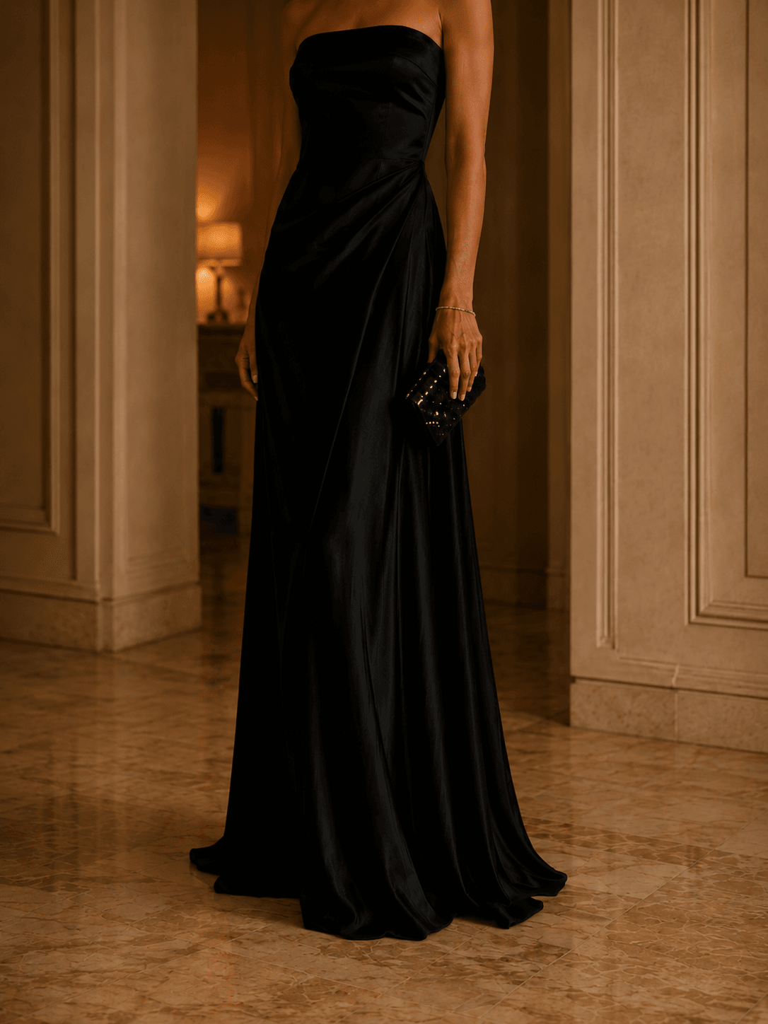 A black floor-length evening gown in warm low light
